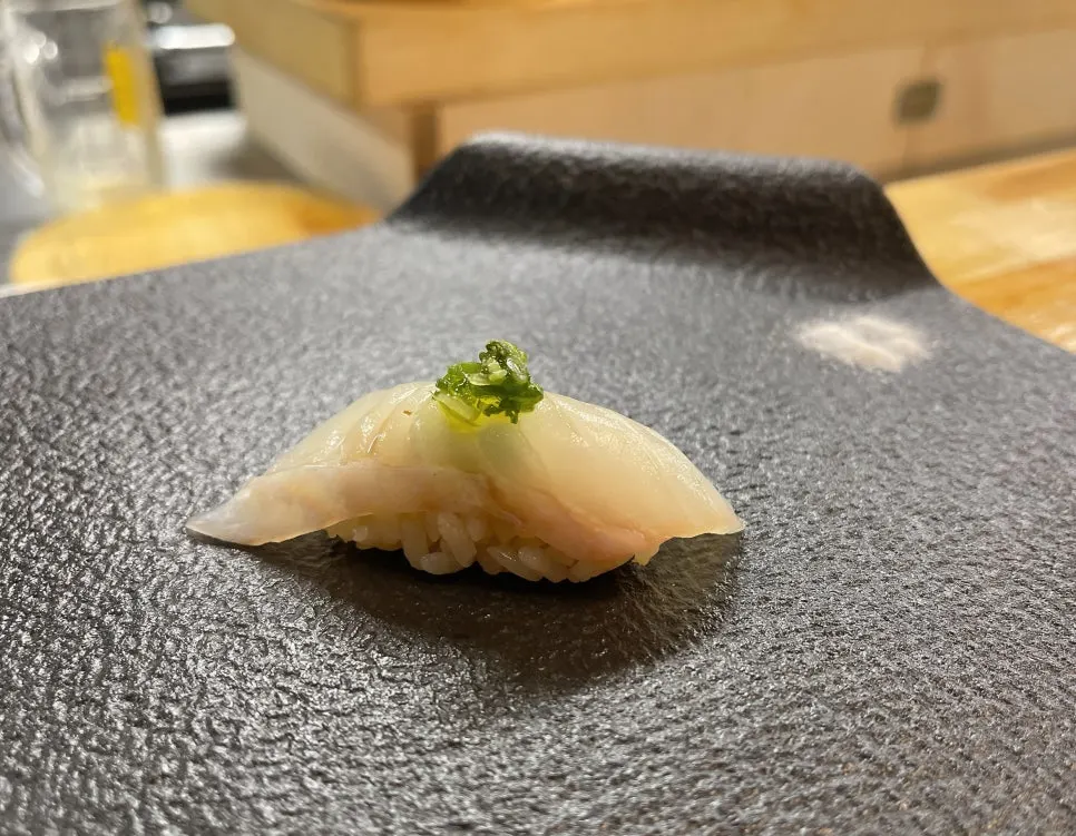 Halibut sushi topped with truffle and chives