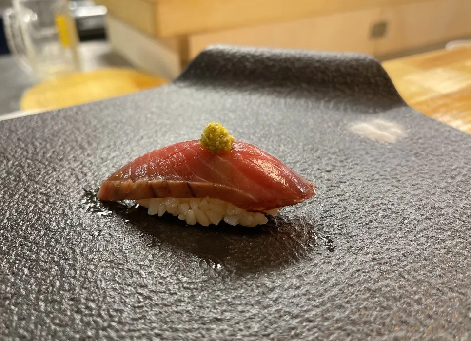 Smoked tuna sushi topped with basil pesto