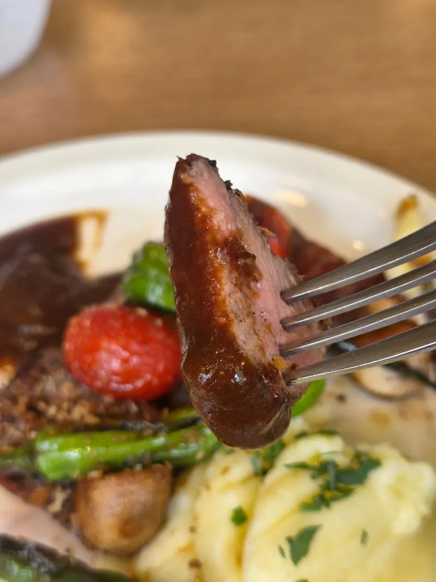 A plate of steak and garnishes