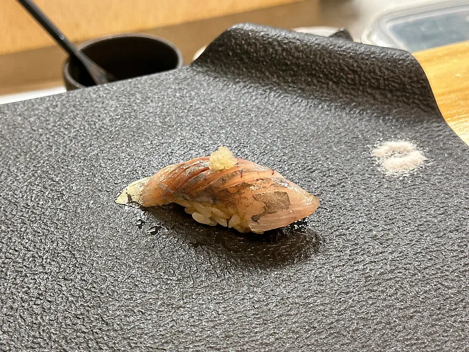 Sushi selection served with ingredient explanations