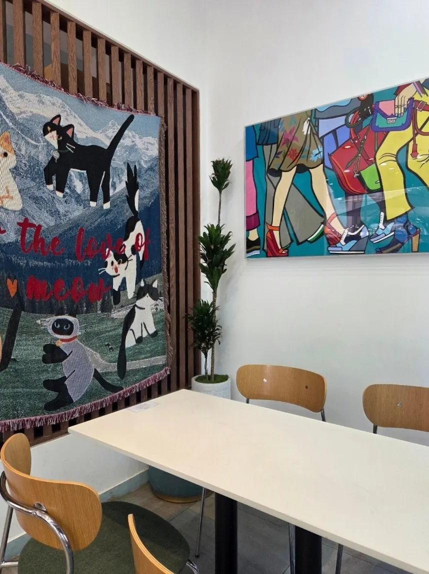 Café interior with floor-to-ceiling windows and pictures