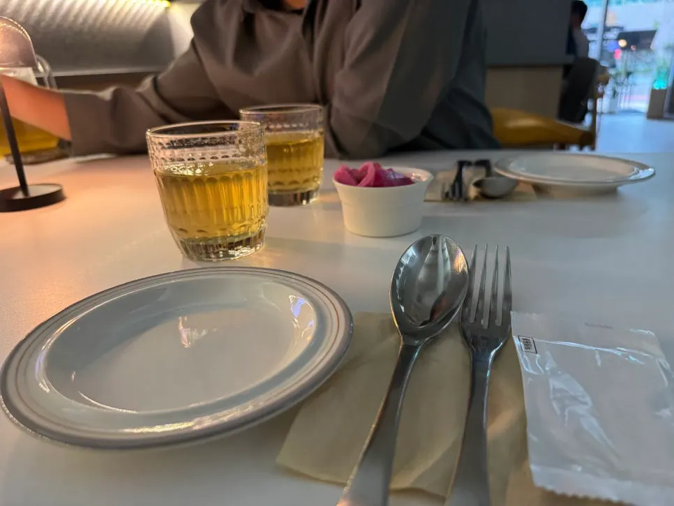 Basic table setting with water, pickles, and small plates