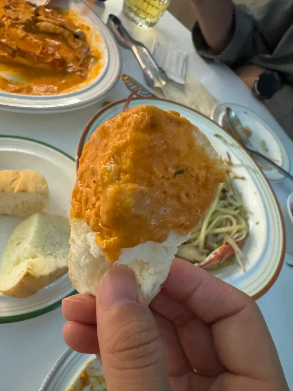 Dipping bread into the rose sauce