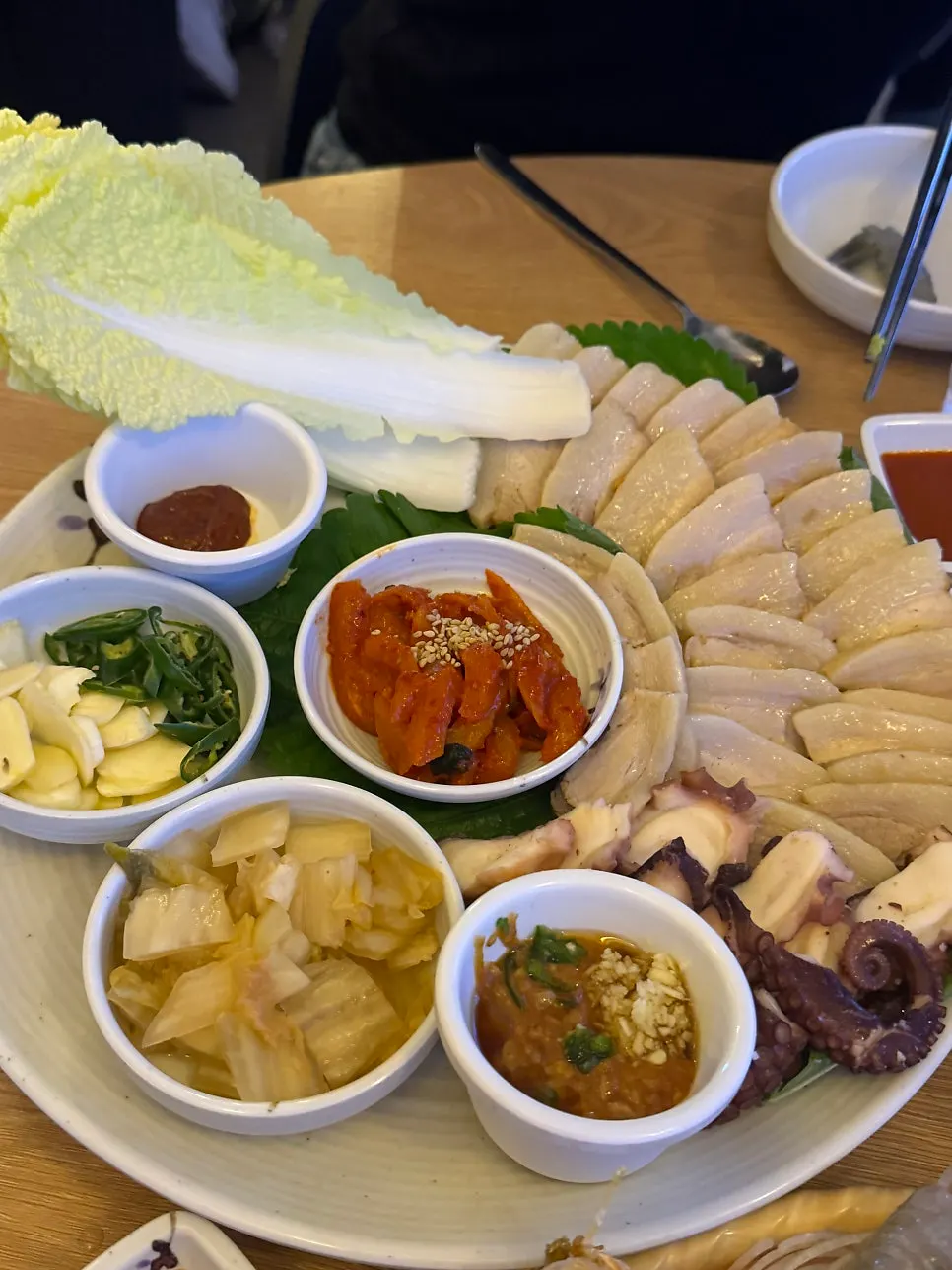 A plate combining bossam, kimchi, and stone octopus