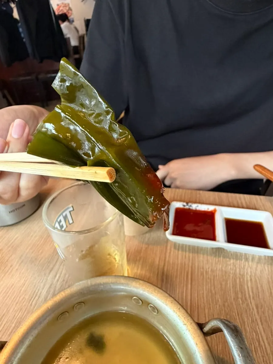 Table spread of seaweed soup and seaweed salad
