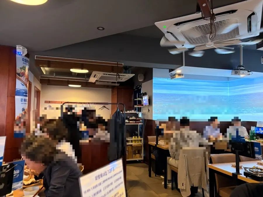 Wall with ocean imagery projected and large window seating