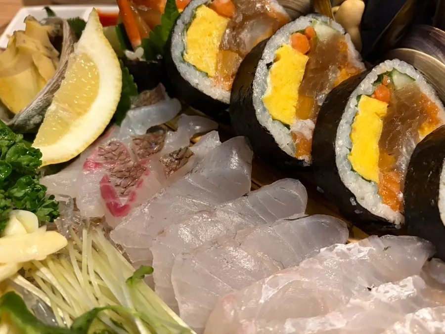 Plate of chewy aged sashimi and giant haenyeo gimbap