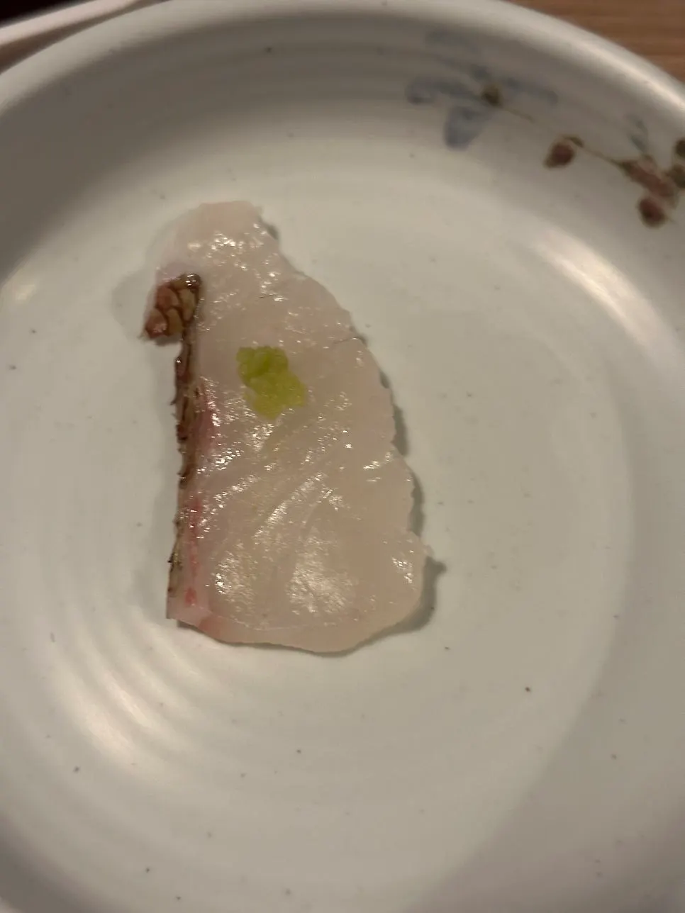 Close-up of a single piece of aged sashimi