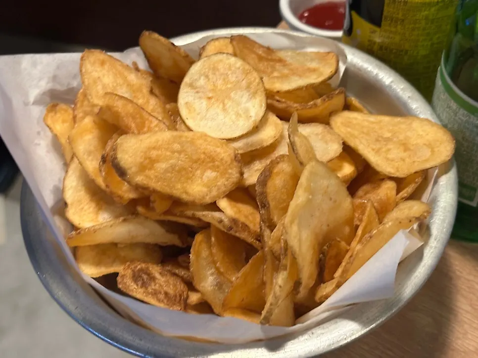 A large bowl piled high with potato chips
