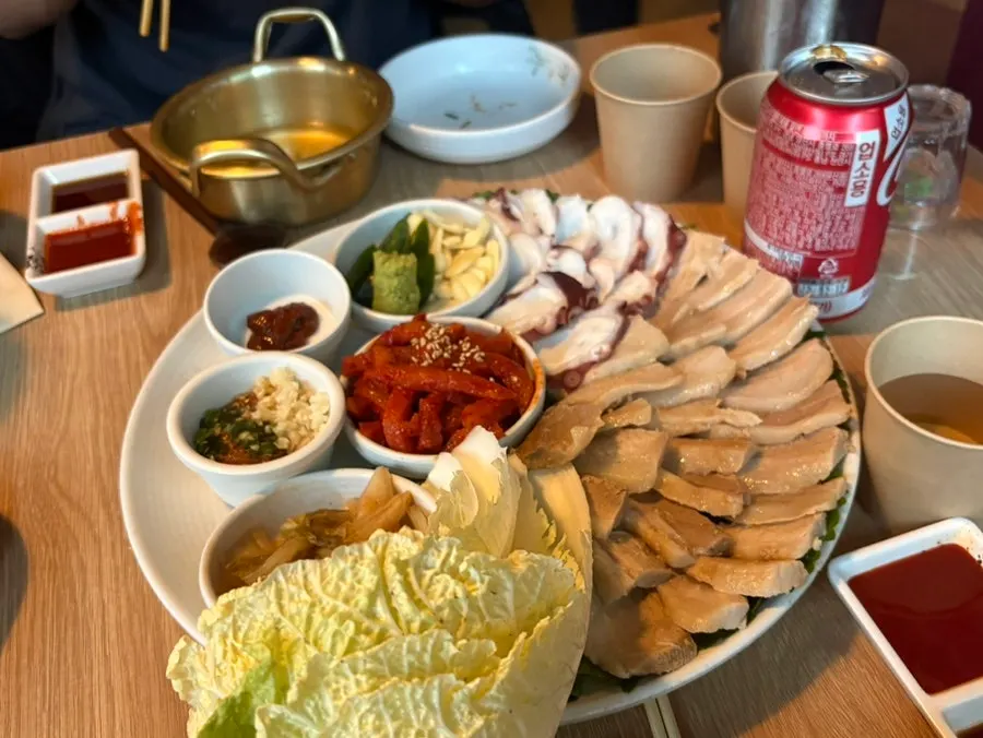 Octopus samgyeop bossam served with aged kimchi, dried radish strips, and napa cabbage