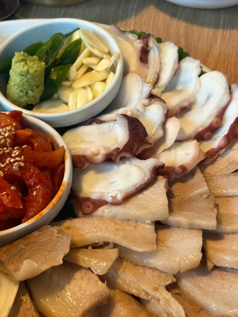 Bossam plate with dried radish, garlic chili, ggosiraegi, and makjang sauce