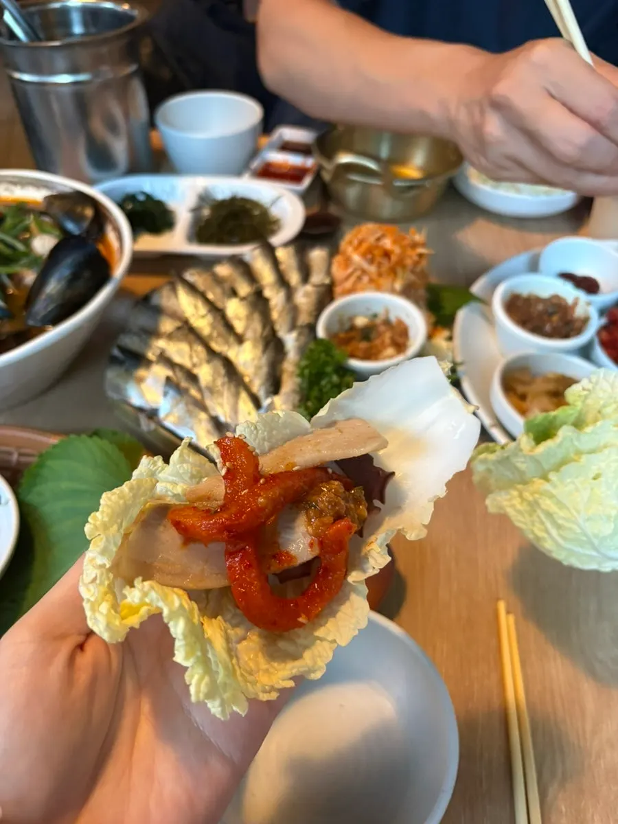 A cabbage wrap loaded with octopus and aged kimchi