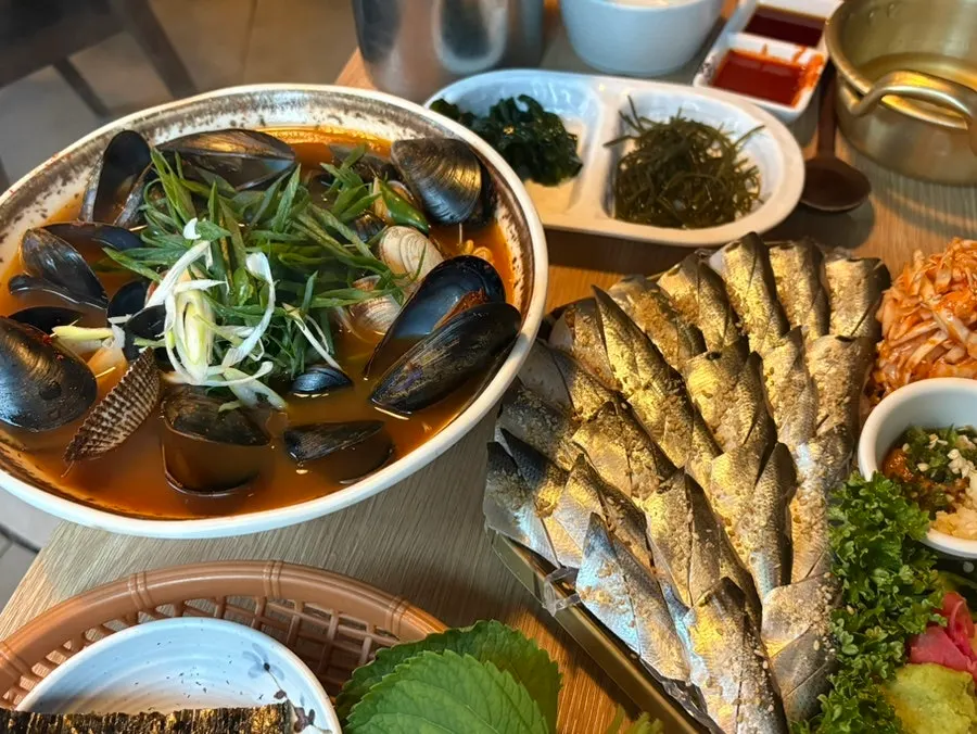 Table spread of seasonal jeoneo sashimi and seafood ramyeon set