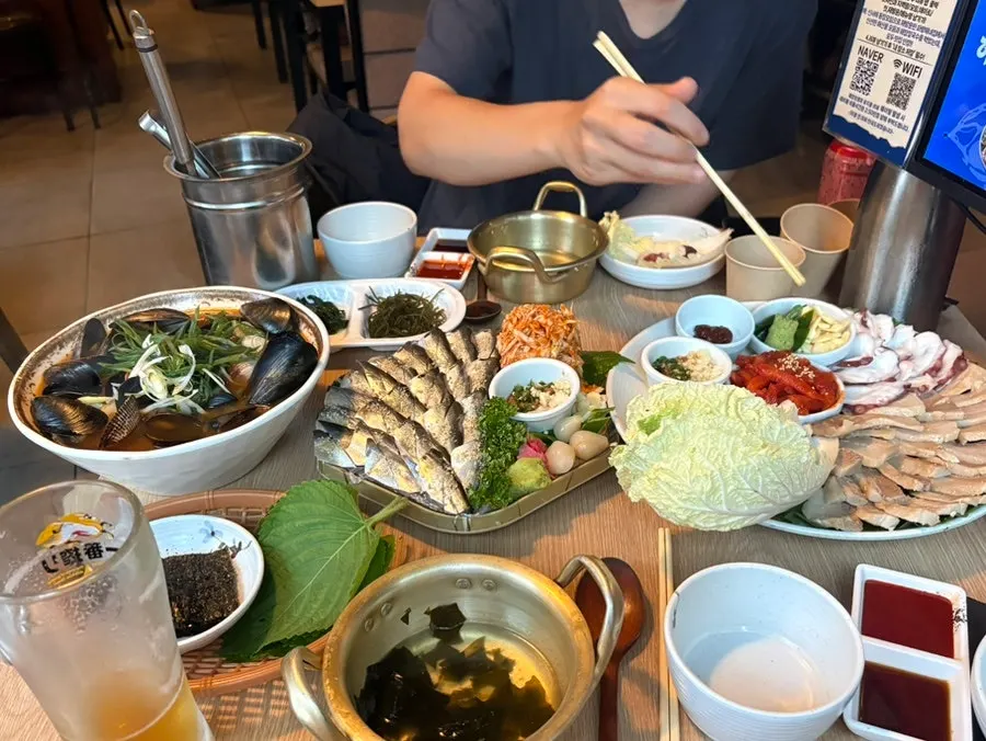 Full table of jeoneo sashimi and bossam ordered by two people