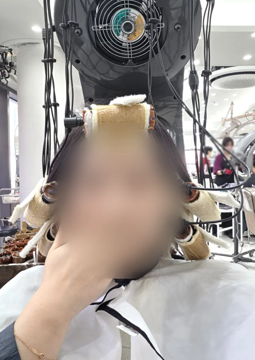 Hair undergoing heat treatment after heat protectant is applied