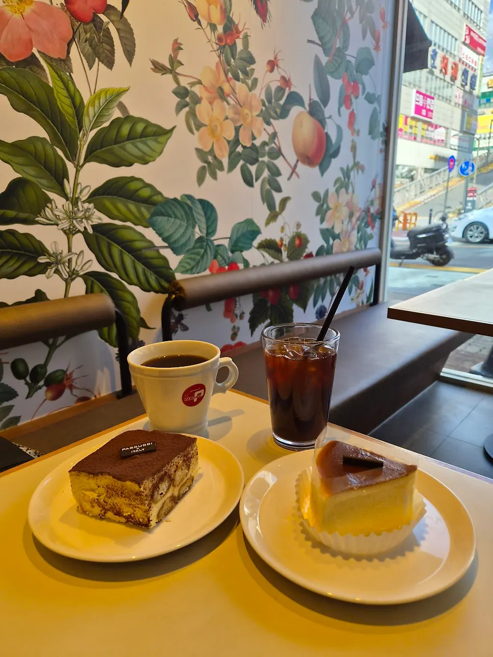 Table with an Americano and two kinds of dessert