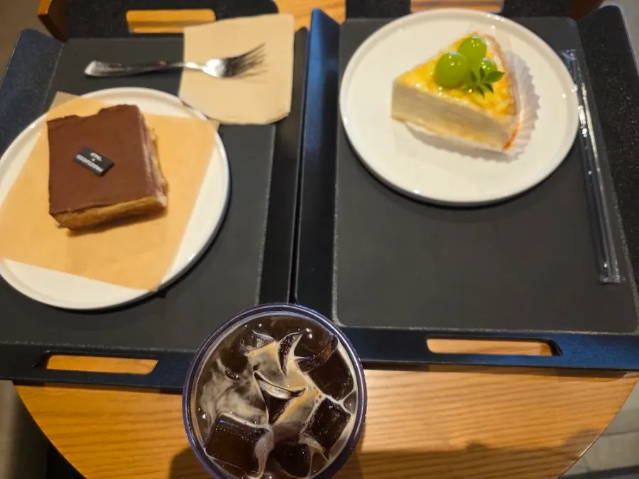 Two slices of cake with an iced americano