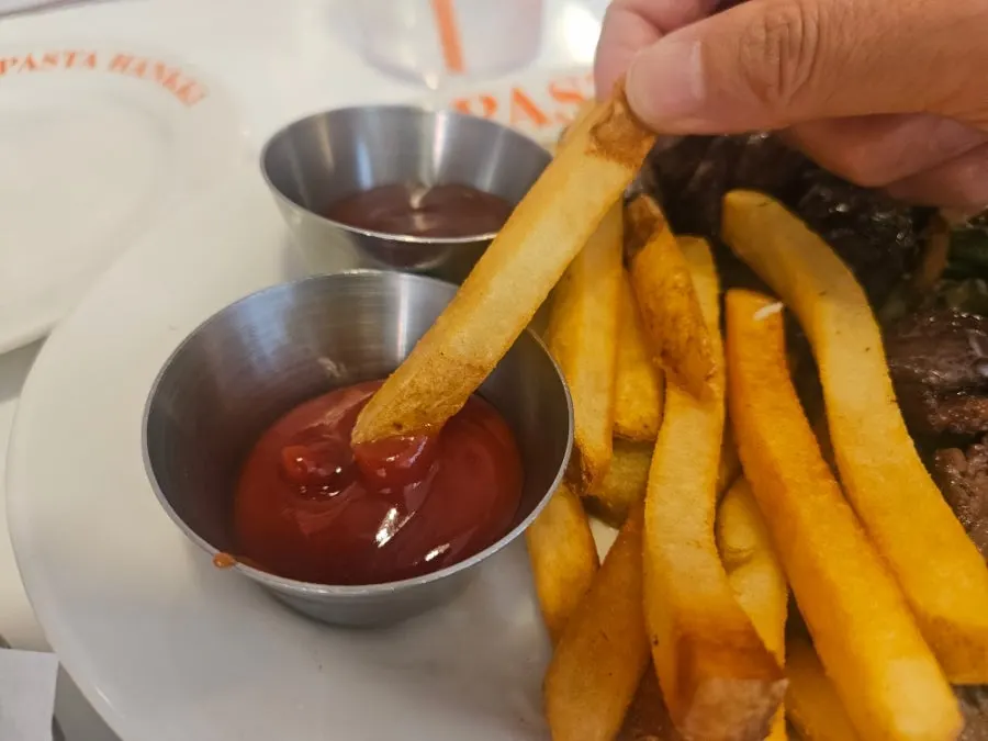 A piece of skirt steak dipped in sauce