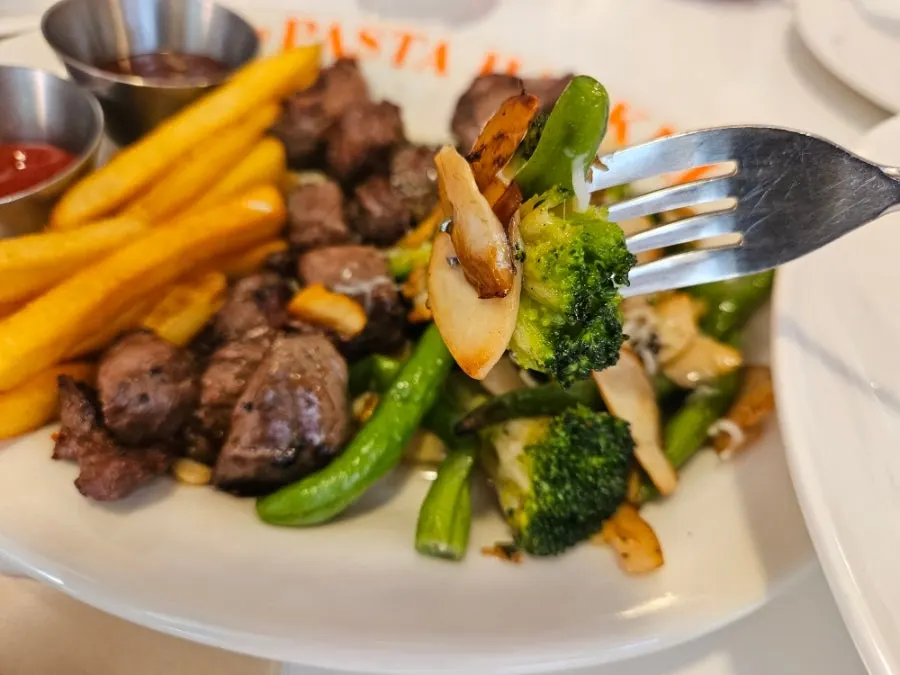 Potatoes and grilled vegetables served with the steak