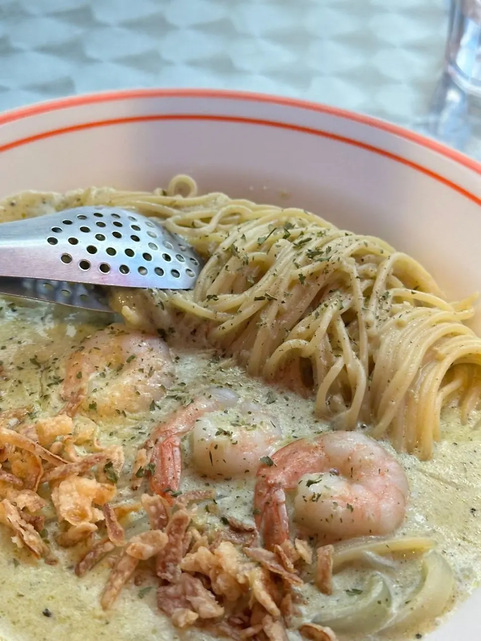 A plate of shrimp basil cream pasta