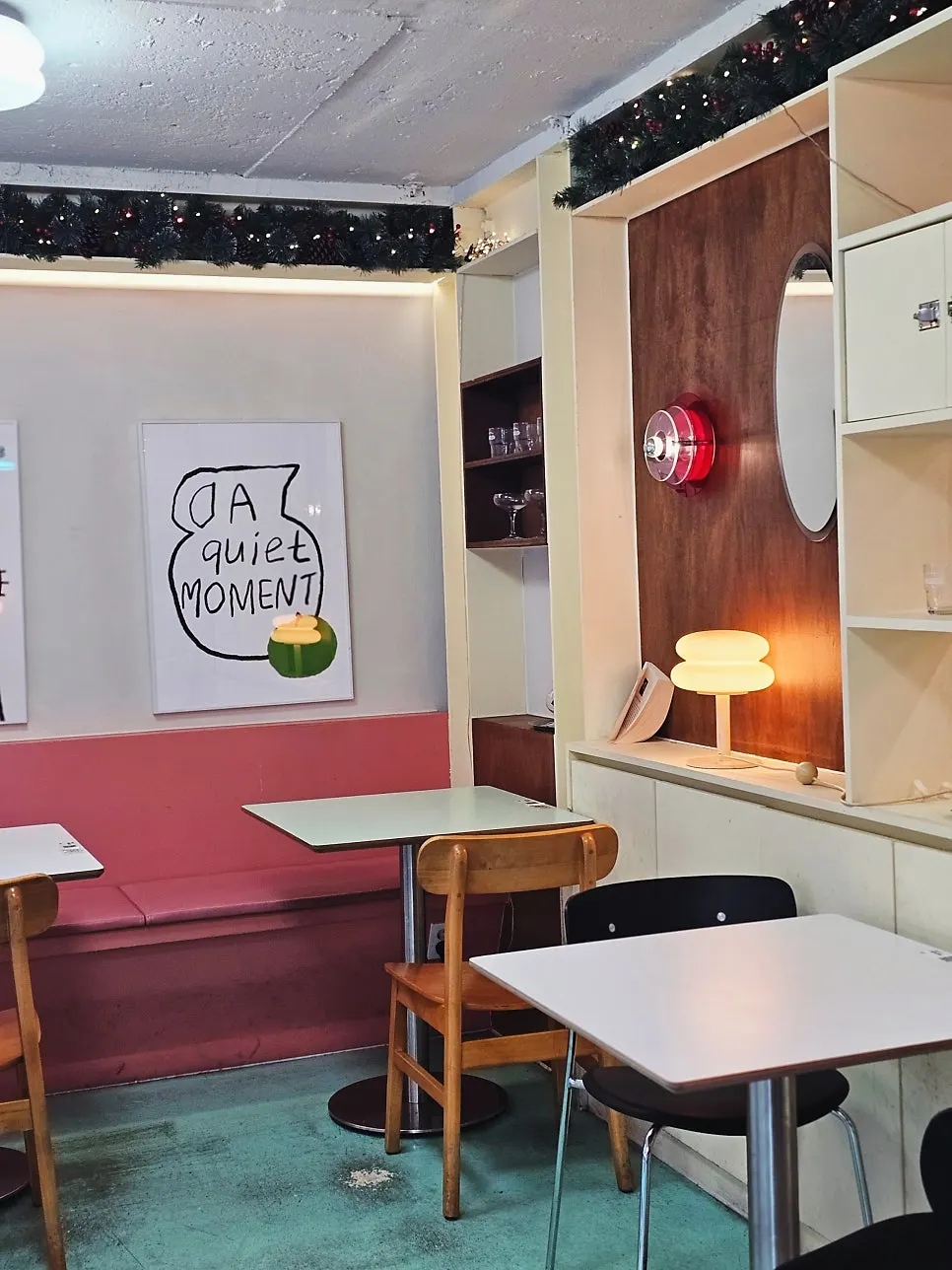 Two-person table with a character frame on the wall