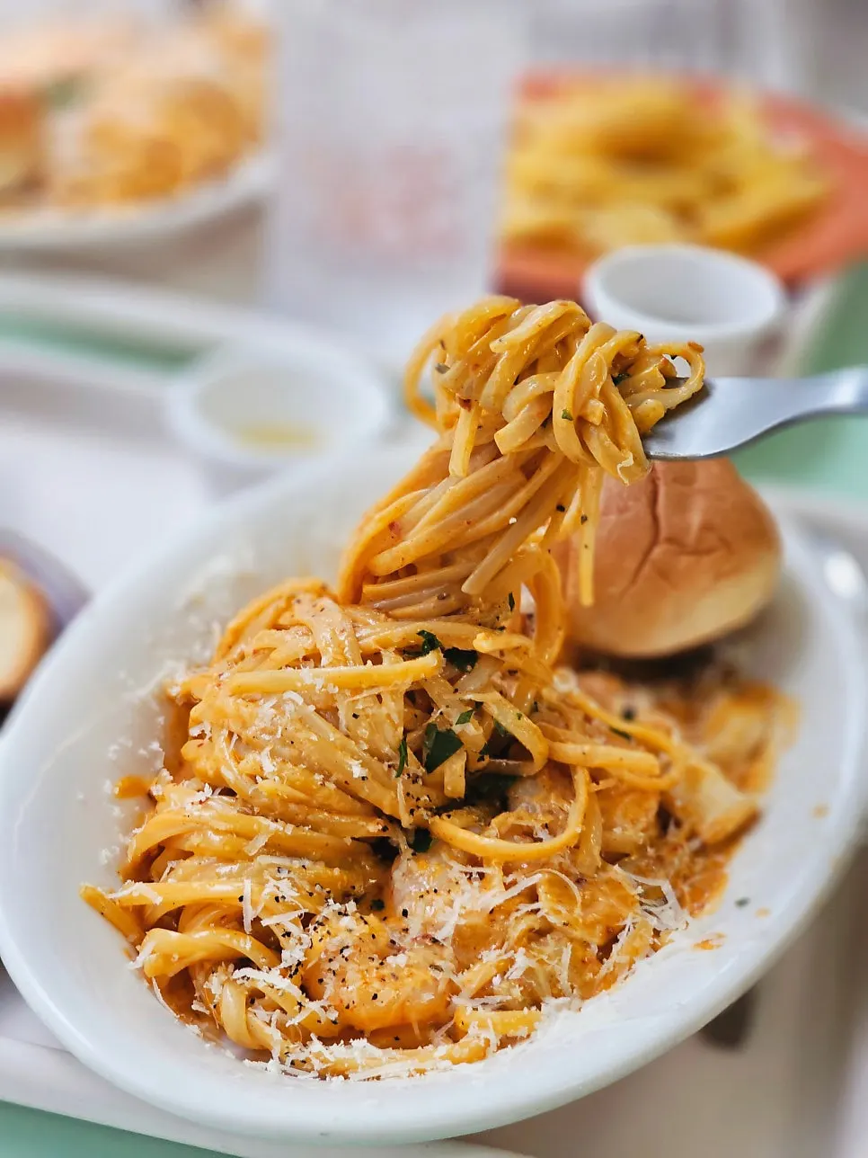 Mala rosé pasta noodles lifted with a fork