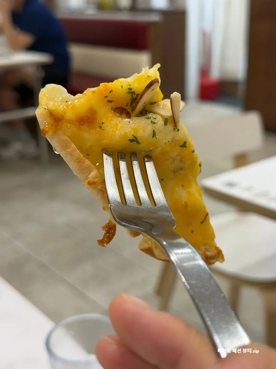 A slice of gorgonzola pizza dipped in honey