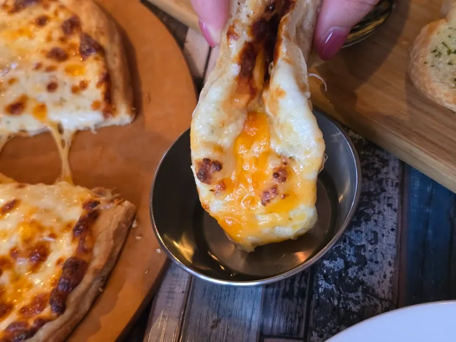 Stretchy cheese pizza paired with honey