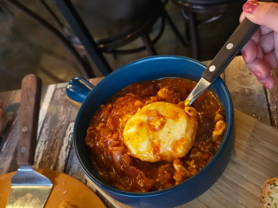 Egg in Hell served with garlic baguette