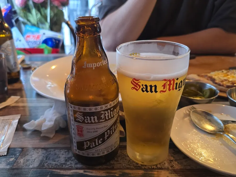 San Miguel bottled beer with side snacks