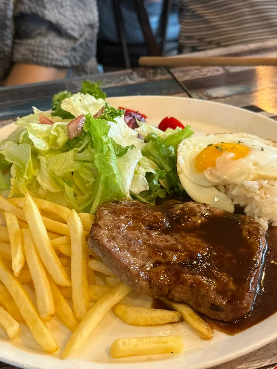 Pork neck steak served with rice and a fried egg