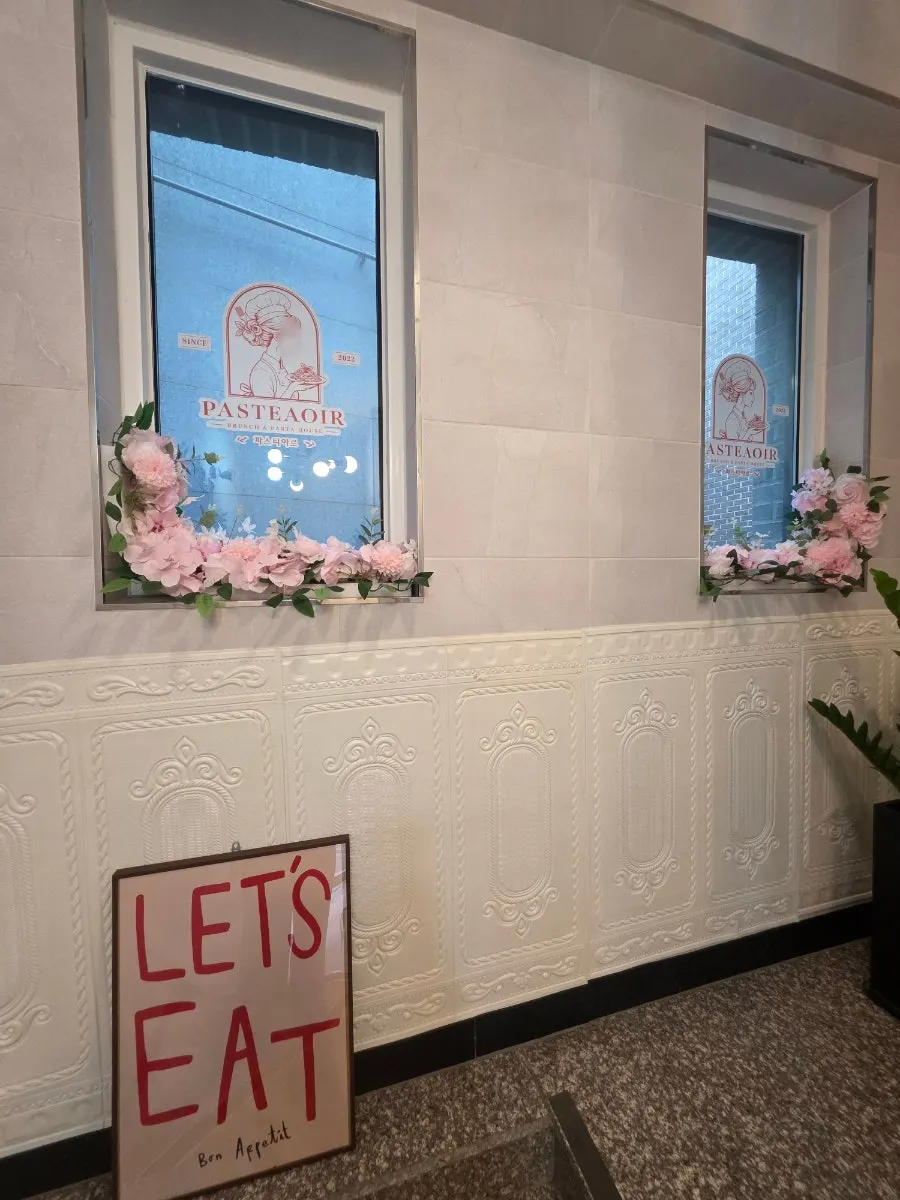 Pastiar's entrance with logo and flower decorations