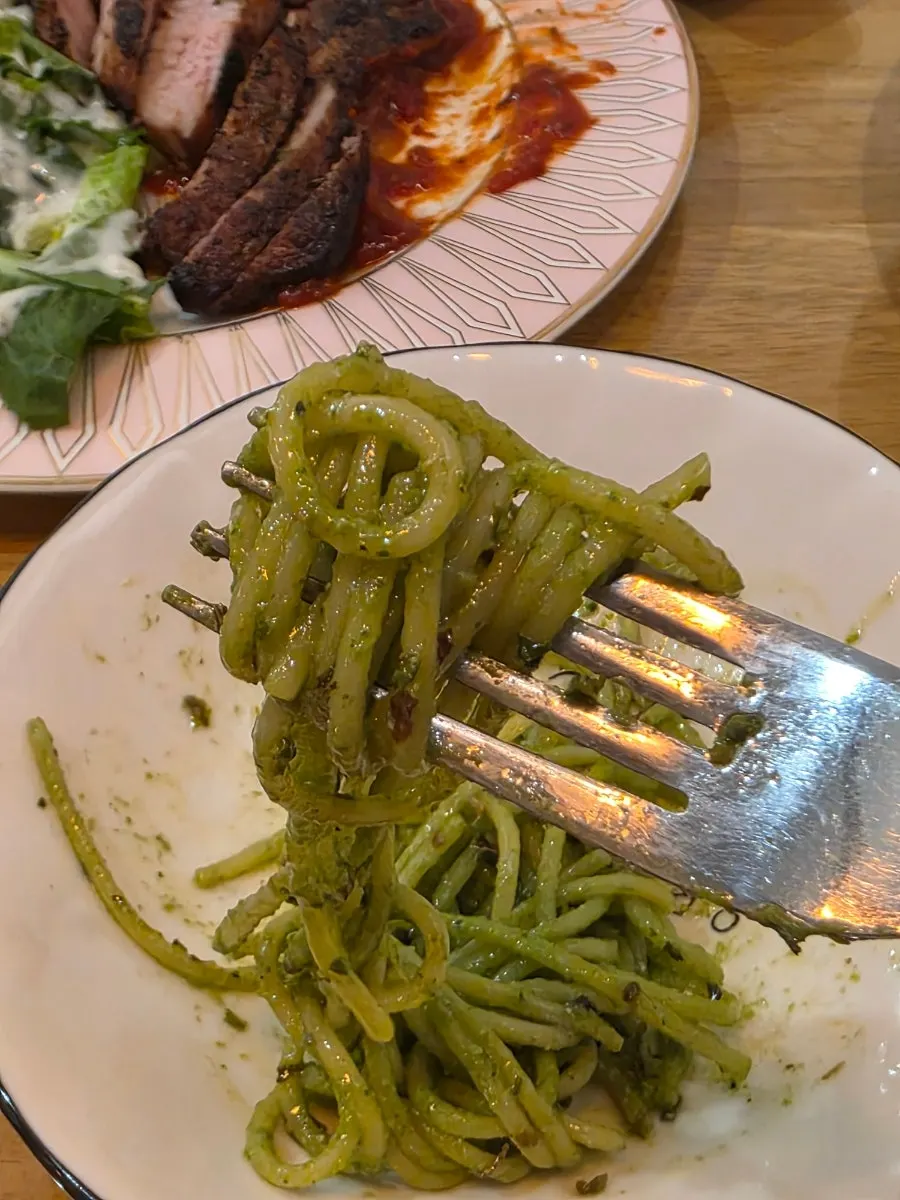 Close-up shot of a plate of basil pesto pasta