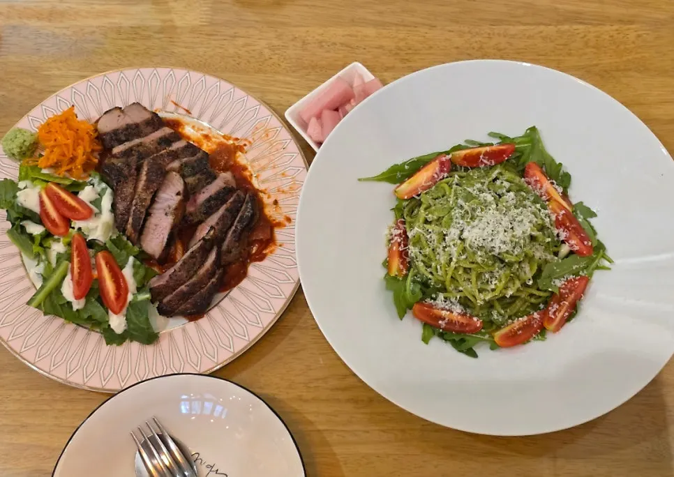 Table with both steak and pasta served together
