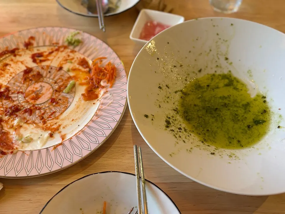 Strands of basil pesto pasta coated in sauce