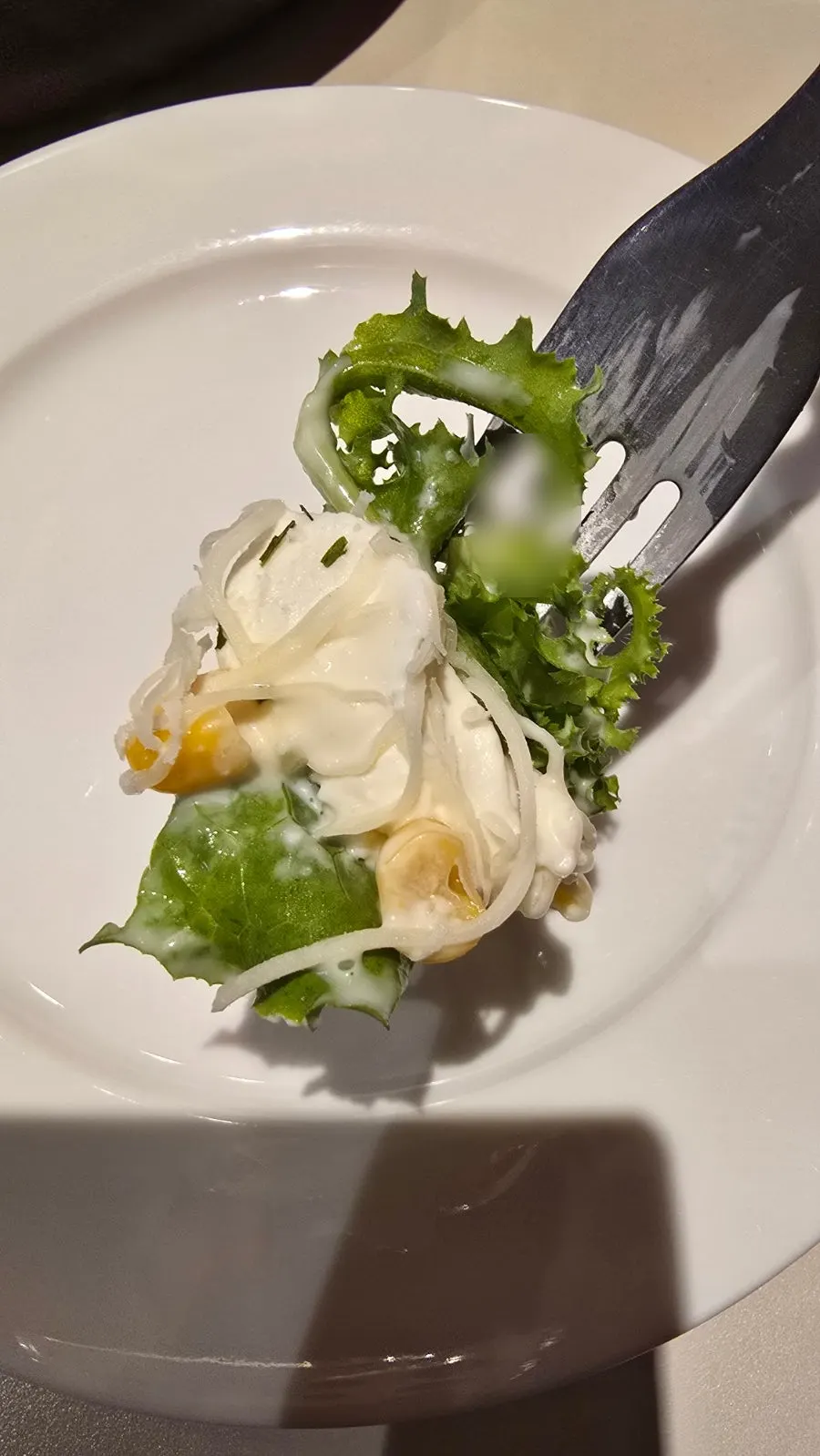 Fork lifting ricotta cheese and vegetables