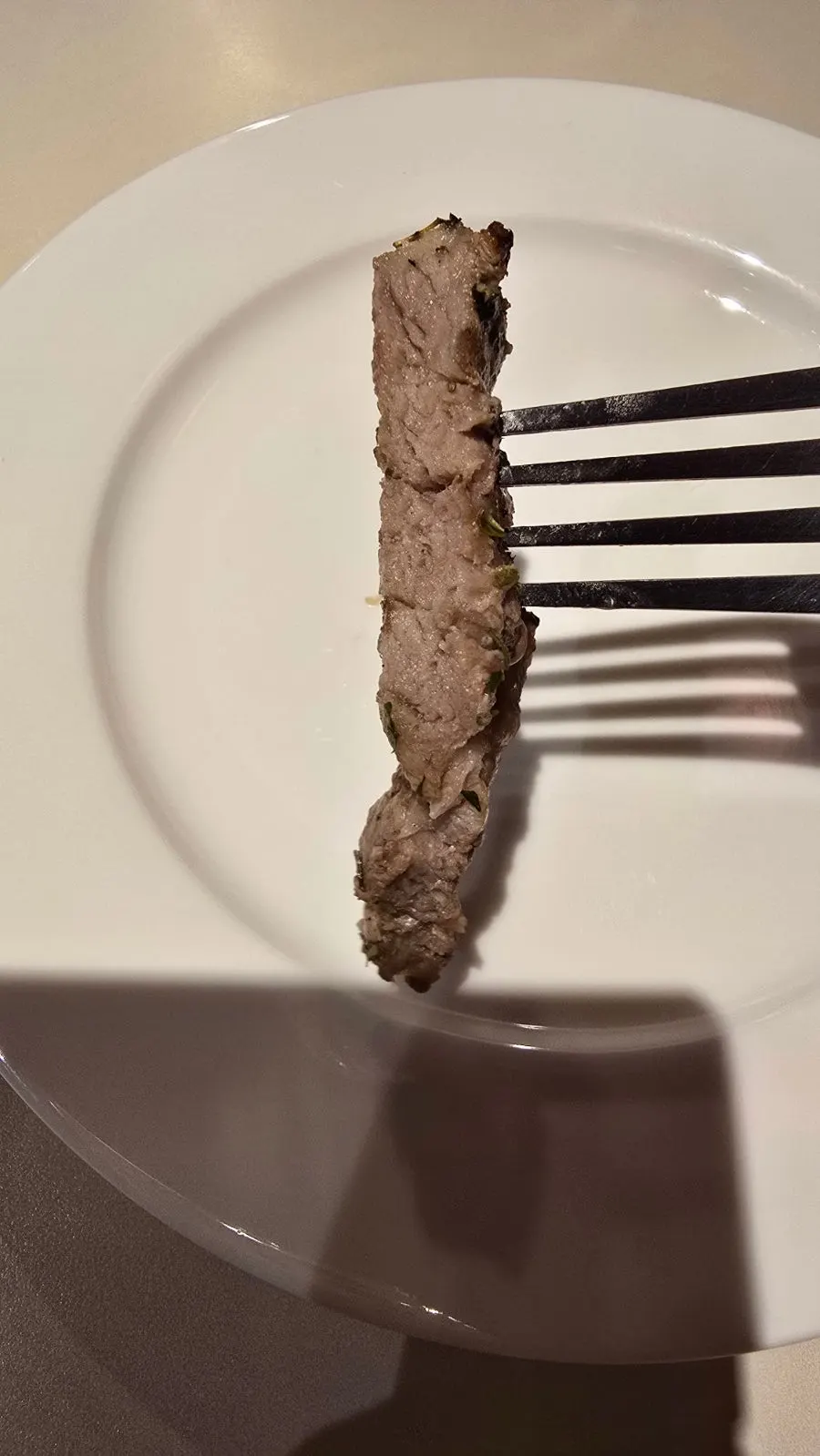 A bite of risotto with cheese and pork jowl