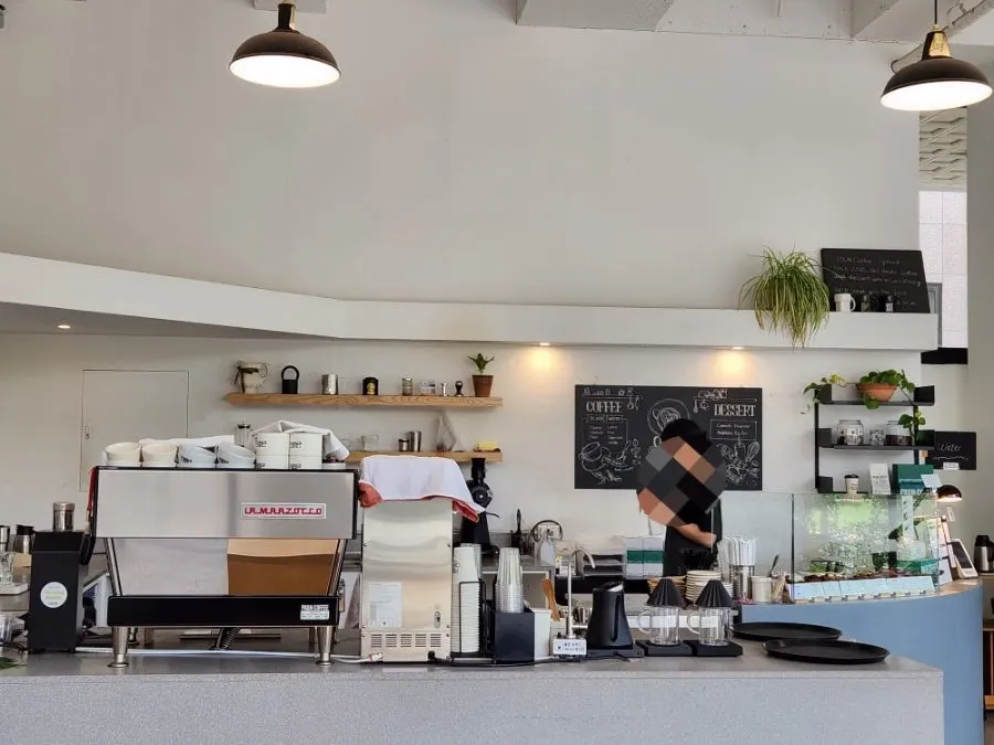 Interior of Pound Coffee lit by floor-to-ceiling windows