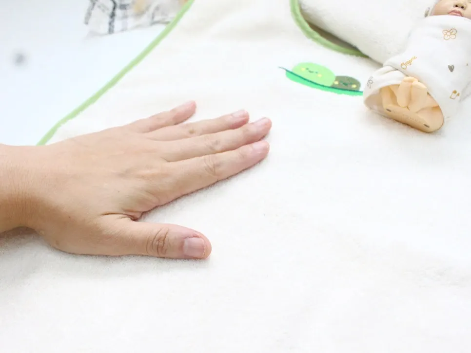 Pressing a hand into the thick towel fabric