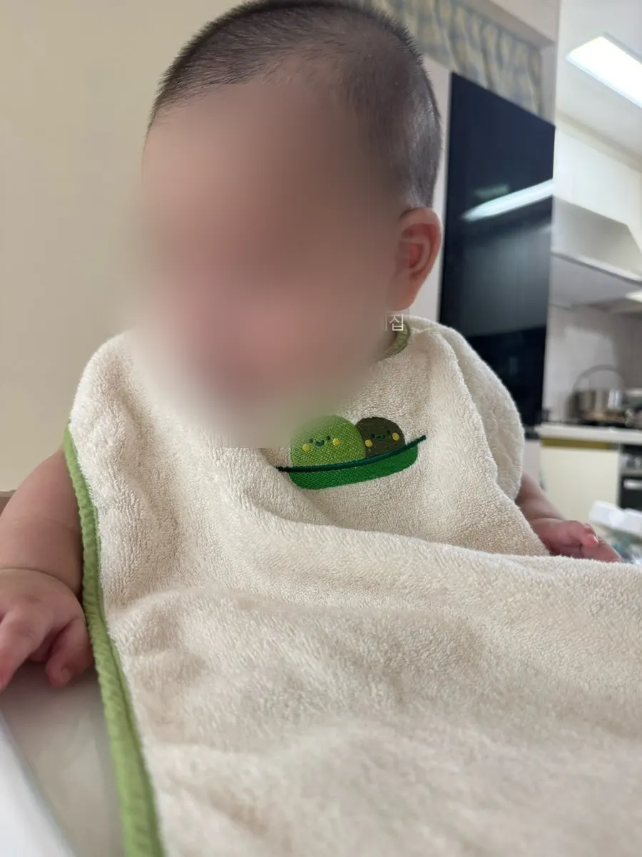 Baby wearing the wash-bib as a drool bib