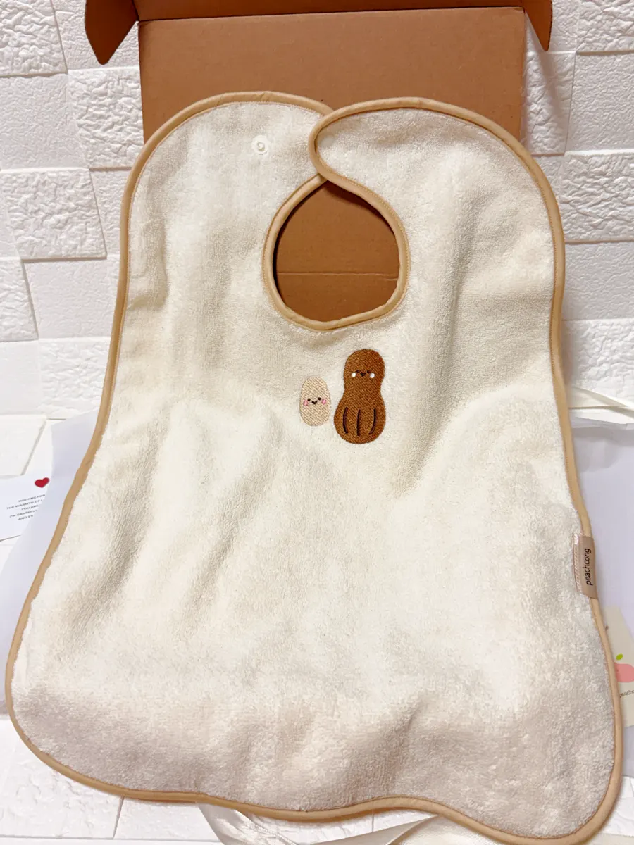 Wash bib with pea and peanut embroidery