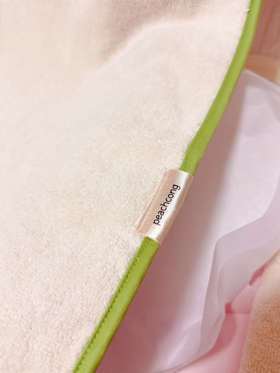 Baby wash bib wrapped around a hand