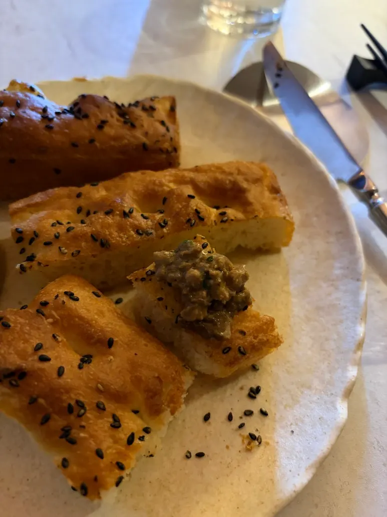 Ciabatta dipped into the pasta sauce