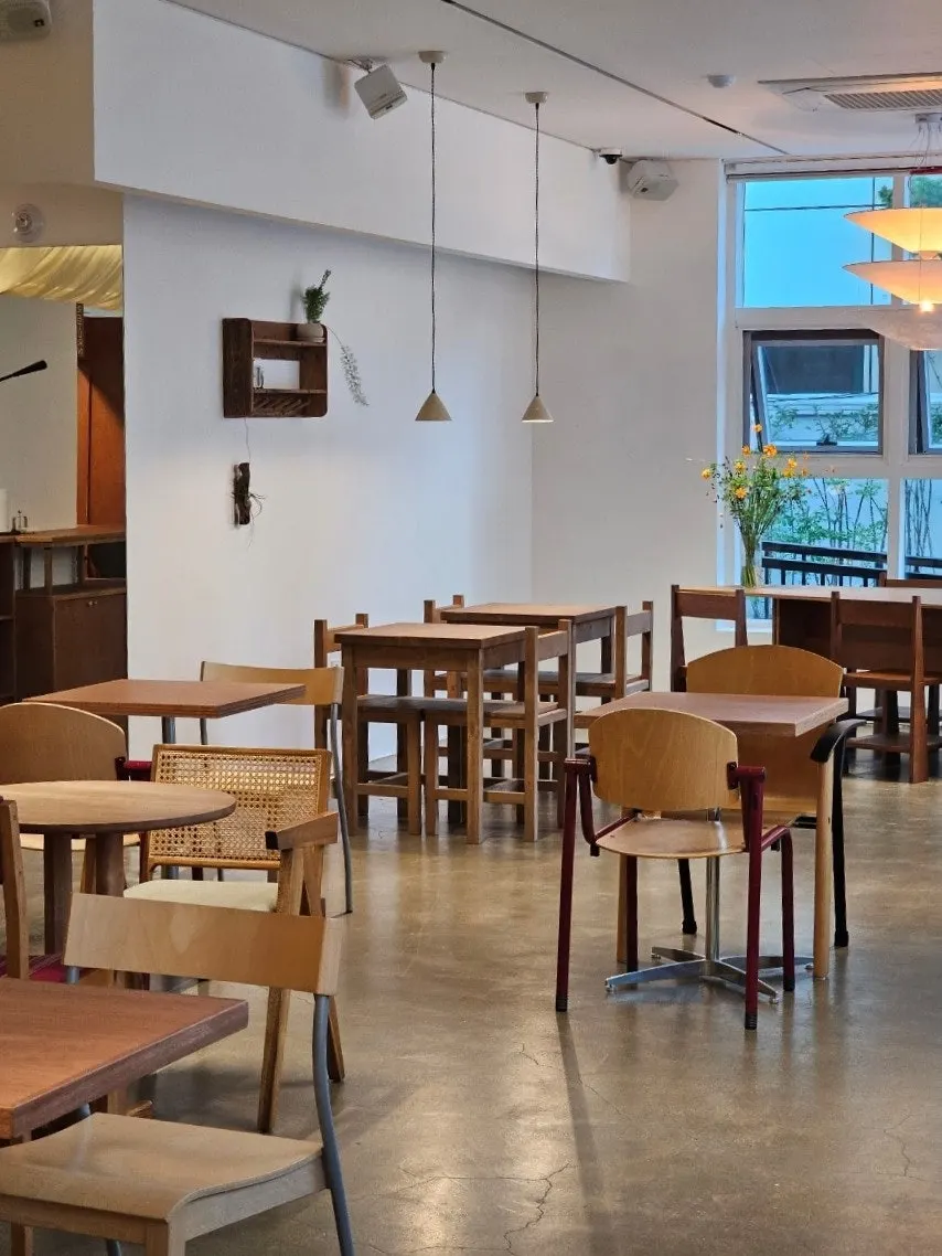 Café interior with high ceilings and widely spaced tables