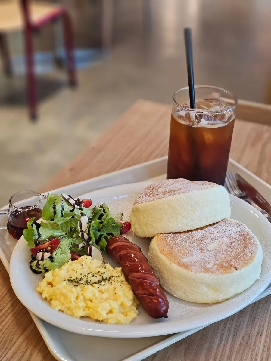 Platter with two soufflés, sausage, scrambled eggs, and salad