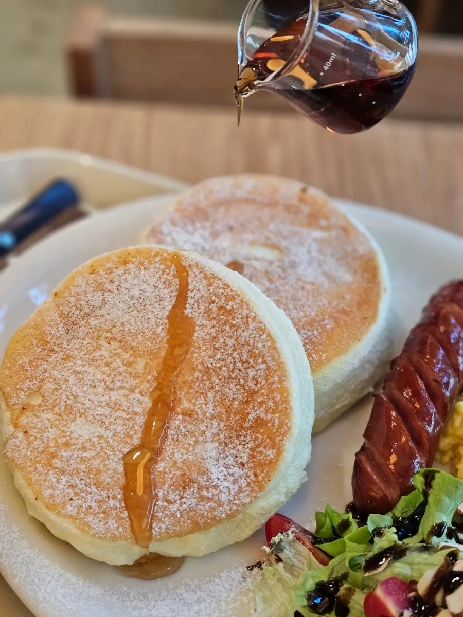 Drizzling maple syrup over the soufflé