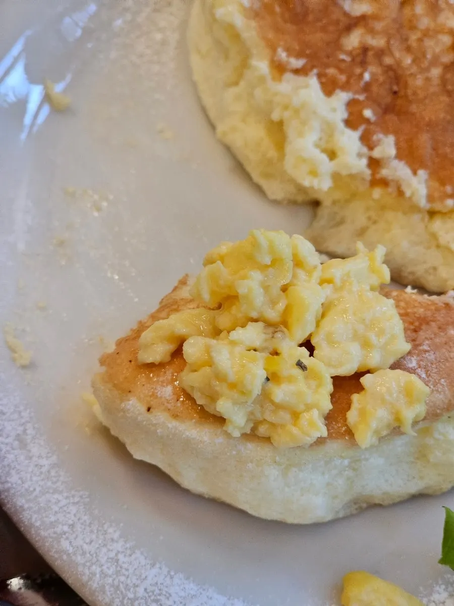 A bite of soufflé topped with scrambled egg