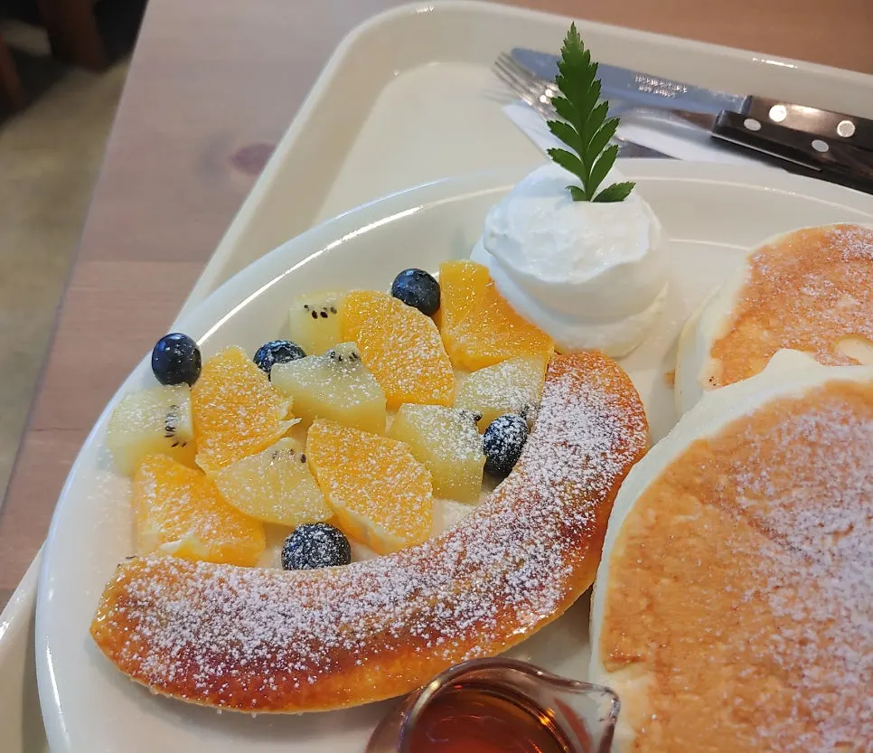 Soufflé topped with kiwi, orange, and brûléed banana