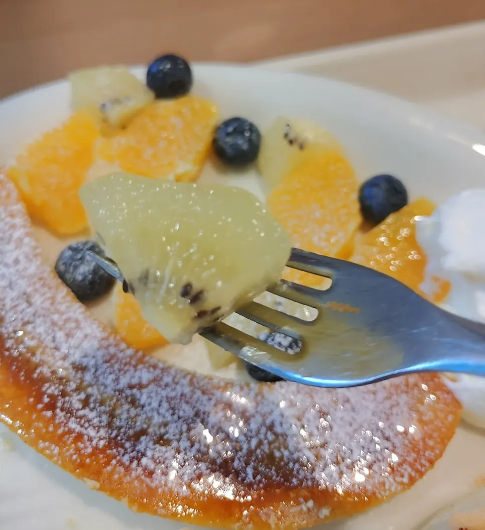 A piece of soufflé with house whipped cream