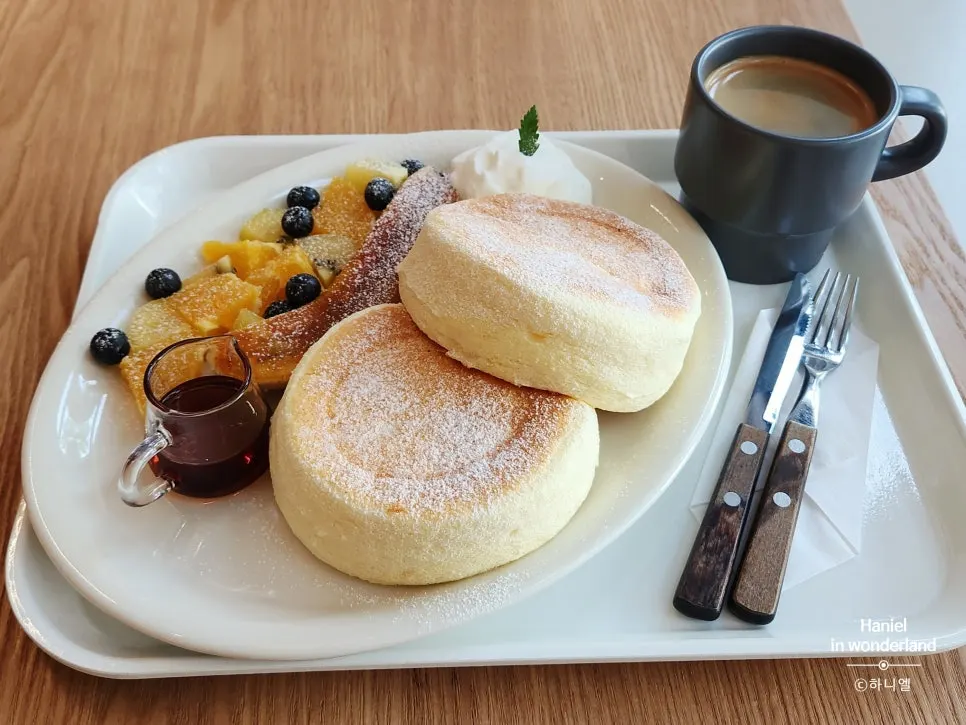 Table setting with fruit soufflé and americano